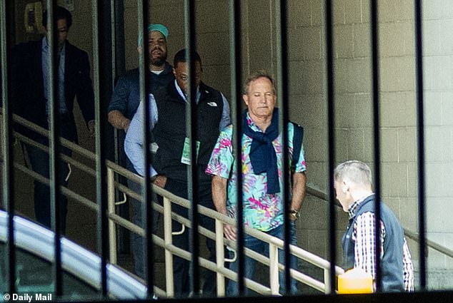 Ken Paxton confidently exits hotel in Hawaiian shirt hours before primary win.