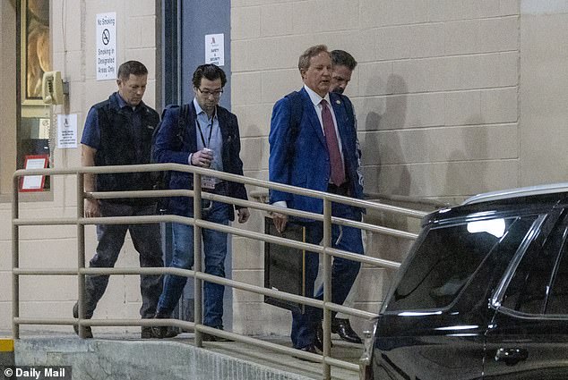 Ken Paxton confidently exits hotel in Hawaiian shirt hours before primary win.